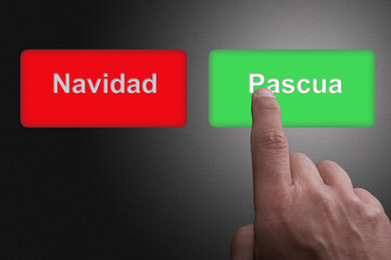 Finger pushing green button with Easter writing, as opposed to red button with Christmas writing in Spanish language
