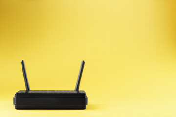 Fototapeta premium Router wireless LAN technology with devices based on IEEE 802.11 standards on a yellow background free space top view.