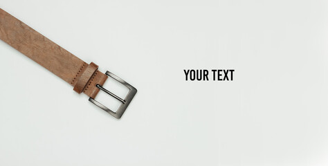 Leather brown belt on a white background. Copy space