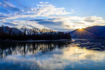 Reflections of the setting sun in the Danube river