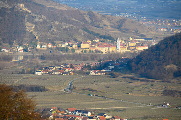 A view from Weißenkirchen over vineyards and Dürnstein ruins in the early spring on a sunny day from above