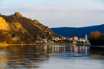 Panorama of beautiful sunlit Dürnstein ruins in the setting sun across the river