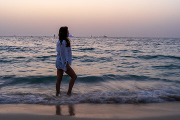 Woman at the beach during the sunset