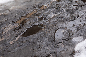 Dirty blurred road with mud and human footprints