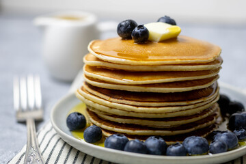 Pancakes with blueberries, butter and honey. Breakfast.