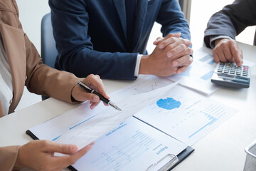 Group of businessmen is discussing in the office about the company profit figures..