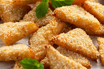 Asian Traditional Prawn Toast with Sesame seeds and sweet chilli sauce on wooden white board