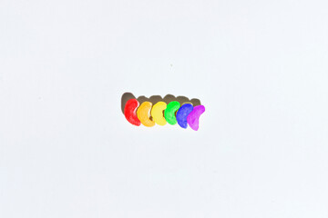 Cashew nuts in a row painted in the colors of the LGTB flag. LGTB concept.