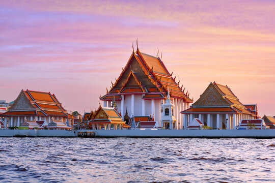 View of the Buddhist temple Wat Kalayanamit Woramahawihan by the Chao Phraya River in the evening. Bangkok, Thailand