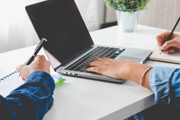 Close up hand of group high school students are studying,learning online academic lesson in university library using the laptop or computer, concept of education.