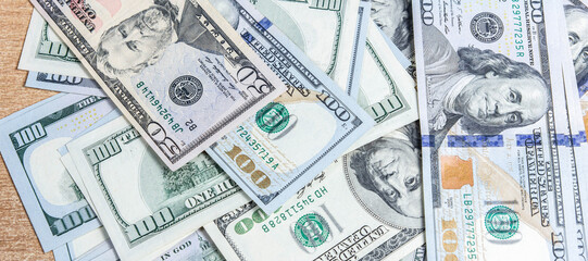 many hundred dollar bills on the table