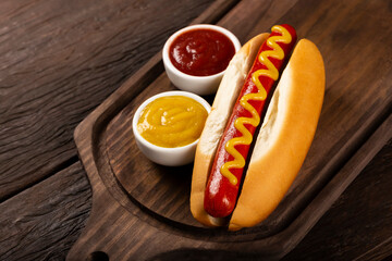 Hot dog with ketchup and yellow mustard.