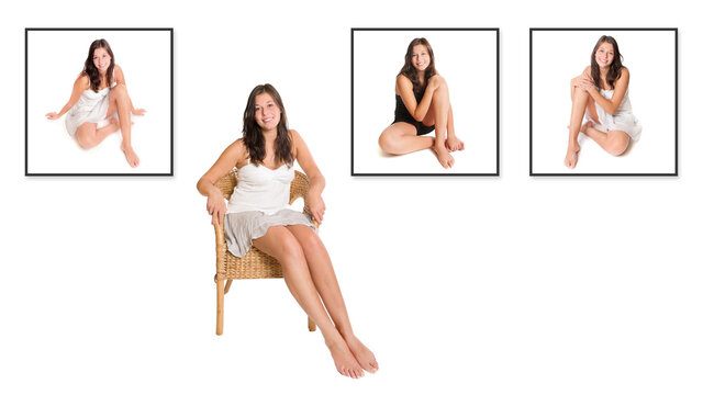 Smiling young woman sitting on a wicker chair in front of three portrait photos of herself, isolated in front of white studio background 