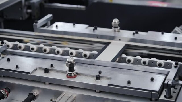 Modern automatic machine line of cardboard box. Conveyor line for the production Manufacture of cardboard boxes from paper. gluing of cardboard.