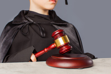 Portrait of serious smart child in graduation cap