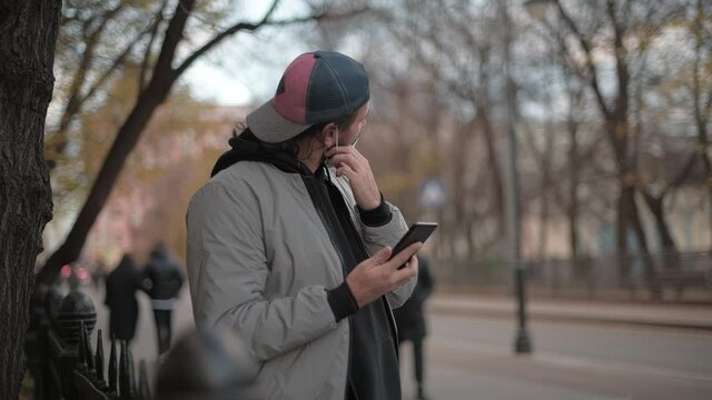Young handsome man talking on the phone on the street of a small town