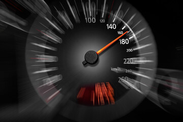 The speedometer of a modern car shows a high driving speed.