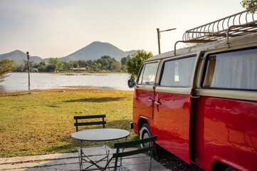 Vintage camper van parked in campsite on lakeside