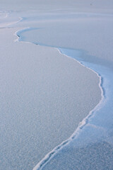 Cracked River Ice and Frost Close-up Winter Snow Surface Background 