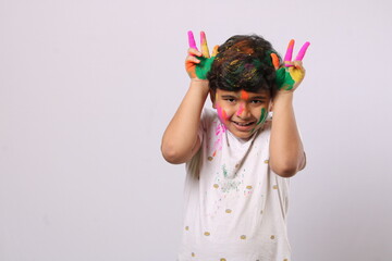 Concept for Indian festival. kid playing with colours or asian children celebrating holi - festival of colours