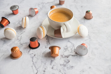 Obraz na płótnie Canvas Cup of espresso, black coffee served with pods and capsules on marble table.Collection of espresso coffee capsules.Caffeine, hot drinks and objects concept.pods for coffee mashine