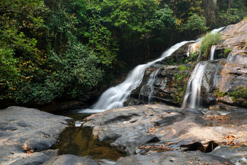 waterfalls is natural beautiful in forest complete of Pha Dok Siew Waterfall Natural Trail in Doi Inthanon National Park, Thailand. The abundance of asian forests.