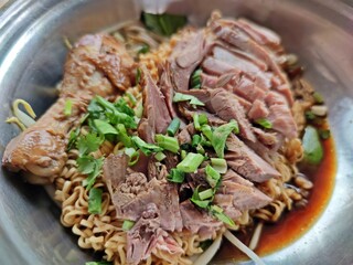 Dried instant noodles with braised chicken and drumstick. Thai street food.