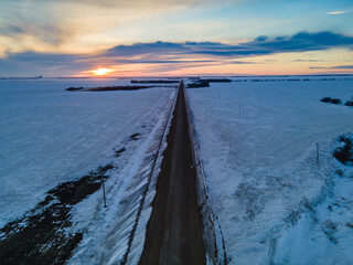 A beautiful view of the sun setting in a rural area of the prairie province of Saskatchewan in the winter