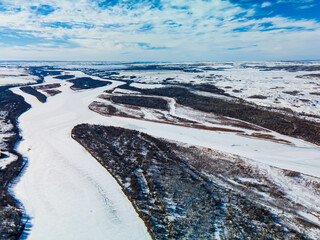 Aerial view of the North Saskatchewan River in a rural area of the prairies during the winter