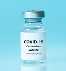 Vial with a vaccine on a blue background. Coronavirus vaccine.The concept of medicine, healthcare...