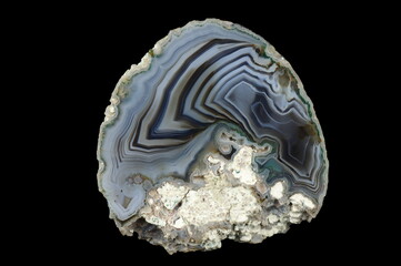 A cross section of the agate stone. Silica bands colored with metal oxides are visible. Origin:...