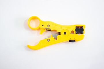 Cable stripping tool. Yellow stripper on white background. Device for cleaning cables and cords.