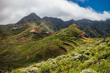 View of fields and village Chinamada with cloudy Anaga mountains in the background