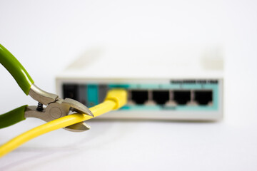 Network cable is plugged into router. Yellow cable in Wi-Fi router. White router with power cord. Router rear view with connections.