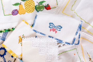 Close up of stitch cloth heart shape, fruits, on white fabric, napkin. Handmade favorite hobby or handcraft, baby patchwork