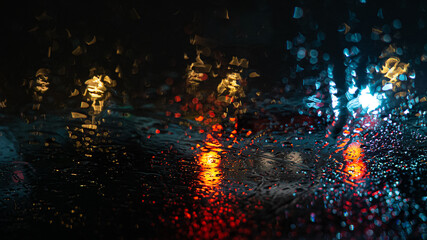 rain on car windows and car brake lights