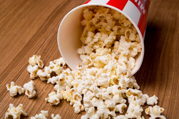 Heap of delicious popcorn isolated on wooden background. popcorn close-up