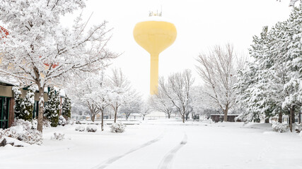 City parking lot in winter with tire tracks in the snow