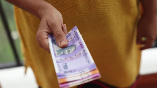 Counting Indian currency Rupee , hand giving Indian money 100, 200, 2000 rupees banknote Kerala India 4K slow motion video, footage. Business woman counting giving money cash new Indian currency notes