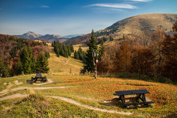 Bench and table for picnic in the autumn mountains