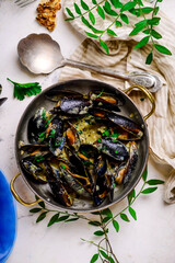 mussels in creamy sauce in a e frying pan.top view