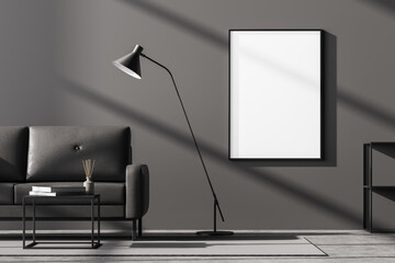 Modern living room interior with one empty poster on dark grey wall, mock up. Furnished by black sofa, coffee table with books on it, chest of drawers and floor lamp.