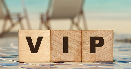 VIP Very Important Person text on wooden cubes on ocean beach. Business concept
