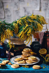 biscuits with lemon with a bouquet of mimosa.style vintage