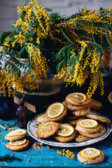 biscuits with lemon with a bouquet of mimosa.style vintage