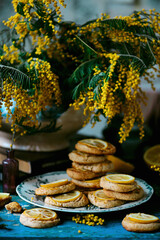 biscuits with lemon with a bouquet of mimosa.style vintage