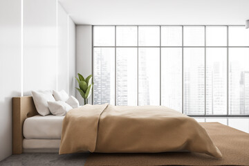 Bedroom interior. Beige bed with linens on carpet near panoramic window