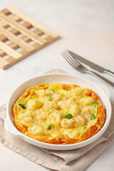 Broccoli cauliflower egg omelette in a plate on the table. Diet nutrition