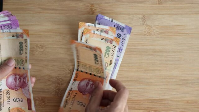 Counting Indian currency Rupee , hand giving Indian money 100, 200, 2000 rupees banknote Kerala India 4K slow motion video, footage. Business woman counting giving money cash new Indian currency notes