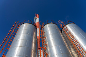 Industrial Storage Tanks Over Blue Sky Background